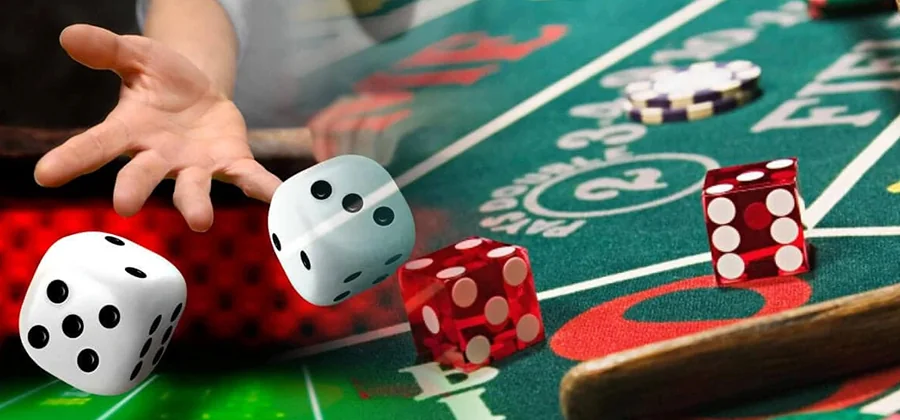 A person holds a dice while engaged in a casino game