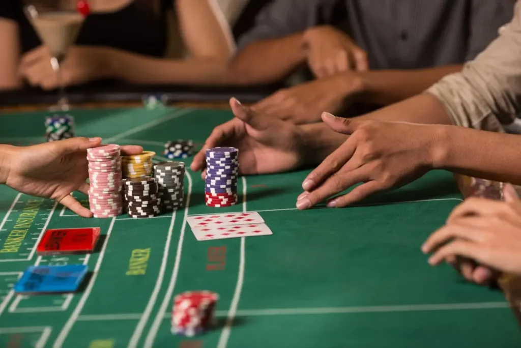 Close-up of a baccarat table with chips and cards