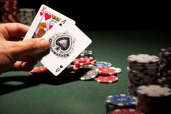Close-up of a player gripping two playing cards