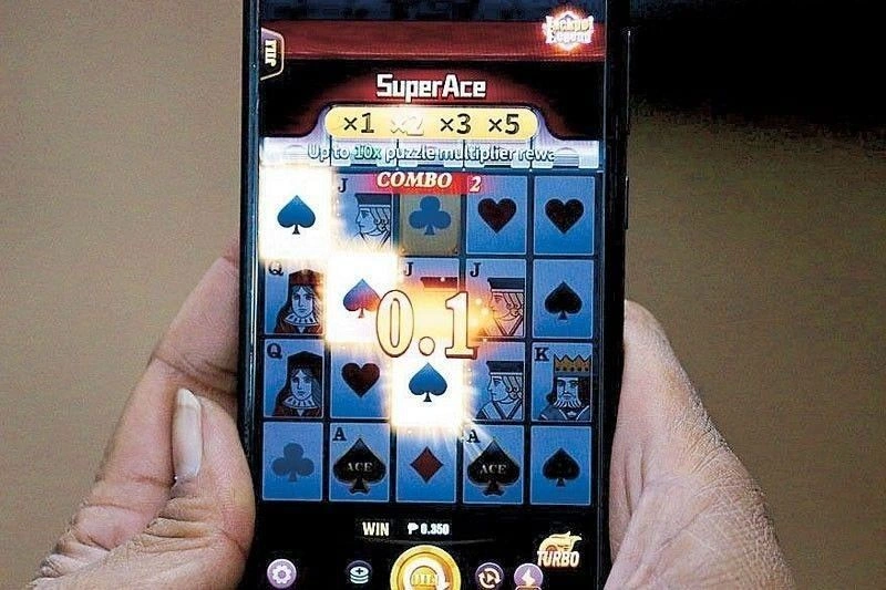 Man holding a smartphone with a casino game on the screen