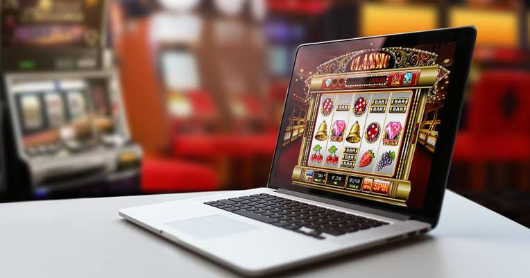 A laptop displaying an online slot machine game