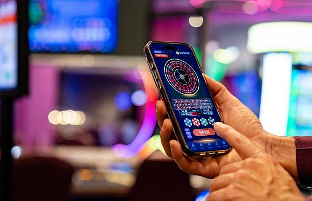 A man displays a smartphone near a casino