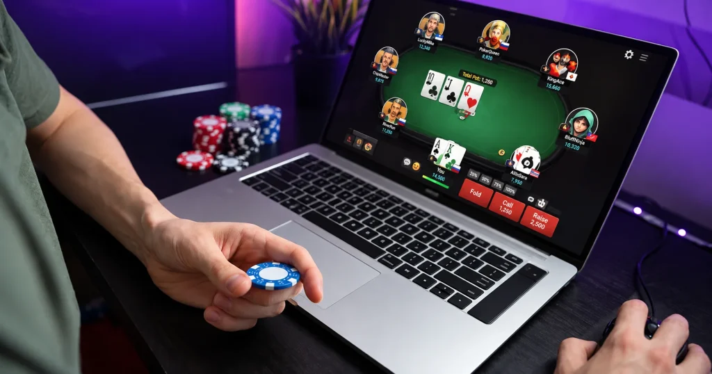 A man engaged in an online poker game on his laptop