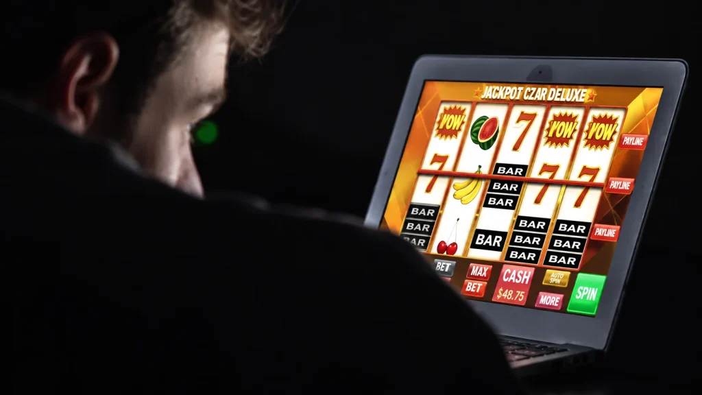 A man engages online casino on his laptop