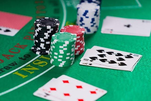 Close-up of a casino table featuring cards and chips