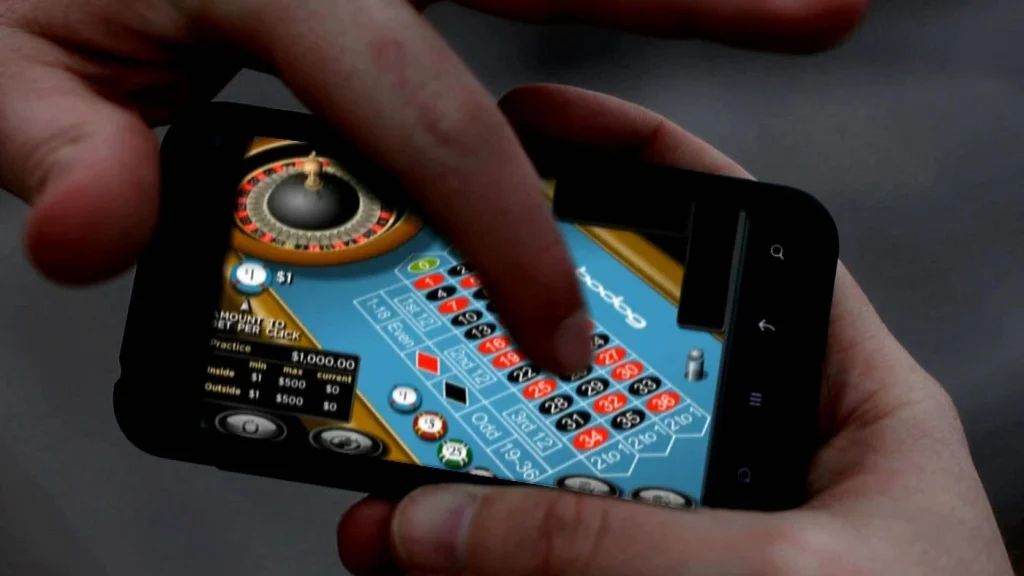 Close-up of a man using a smartphone to play a casino game